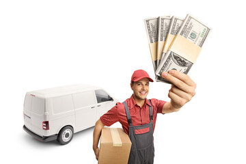 Delivery man holding a cardboard box and money in front of a white transporting van