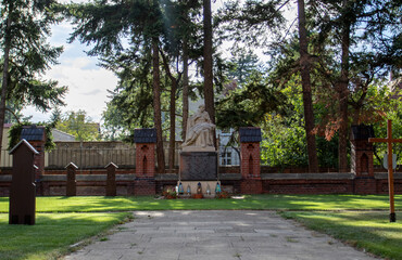 Monk Monument at the cemetery of the Franciscan Order. Sculpted in 1925 by the Franciscan Ferdinand Kempe, it shows a seated monk holding a dying young boy in a German uniform and helmet on his lap