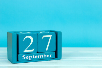 wooden calendar with the date of August 27 on a blue wooden background, World Tourism Day, International Day of the Deaf	