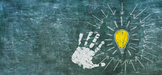 Idea, innovation, solutuion concept weth light bulb and human hand on black board, design template, large copy space