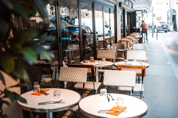 Street view of a coffee terrace with tables and chairs in Europe
