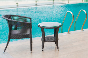Chairs and Table with a part of swimming pool.