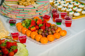 mixed fresh fruits strawberry raspberry blueberry, kiwi mango on white plate