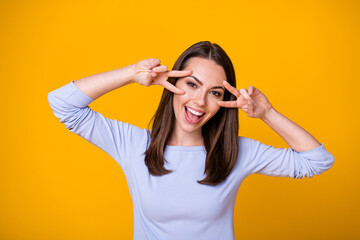 Photo of positive crazy charming youth girl make v-sign enjoy rest relax wear good look clothes isolated over vibrant color background