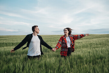 Young Beautiful Couple Walks Outdoors in the Field