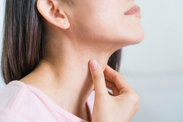 Woman with hands holding her Throat in pain.Health-care Concept.Selective focus