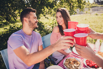 Cropped view portrait of four nice attractive cheerful cheery best buddy fellow guys group spending weekend drinking beverage clinking cups celebrating holiday festal occasion feast backyard house