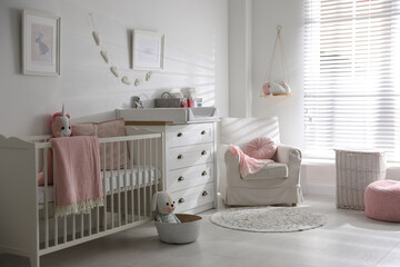 Chest of drawers with changing tray and pad in baby room. Interior design