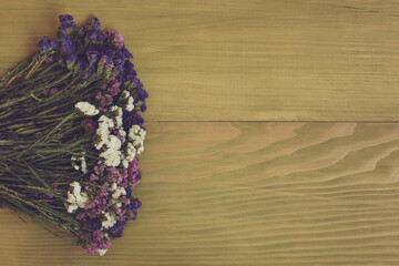 Image of beautiful dried flowers on wooden background.