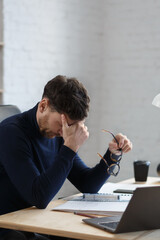 Tired architect working overtime in office. Stressed businessman have financial problems and...