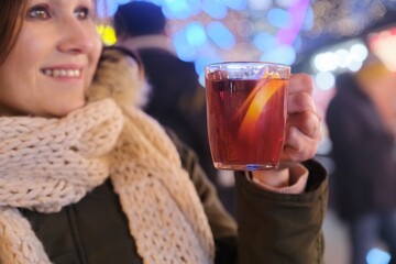 Close-up mug with mulled wine in woman hands