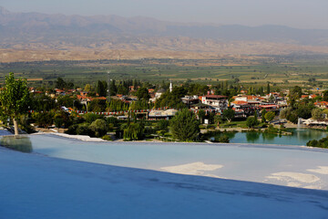 Obraz premium View of the beautiful Pamukkale Travertine pools, known as Cotton castle, at Hierapolis Pamukkale world heritage site in the city of Denizli, Turkey.