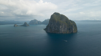 Fototapeta premium Aerial view of some island and a ship sailing in Philippines