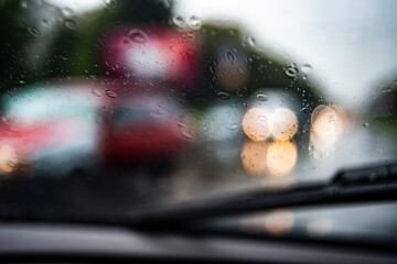 Blurred Defocused Lights of Heavy Traffic on a Wet Rainy. Rainy road at dusk driving.