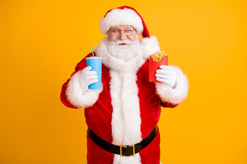 Fototapeta na wymiar Portrait of his he nice cheerful cheery funny white-haired Santa eating fastfood menu recipe weight loss diet isolated over bright vivid shine vibrant yellow color background