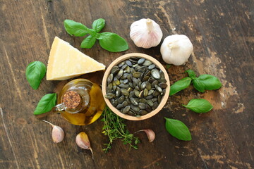 Pesto products: olive oil, pumpkin seeds, basil, Parmesan, and garlic