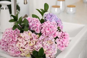 Bouquet with beautiful hydrangea flowers bouquet in sink, closeup