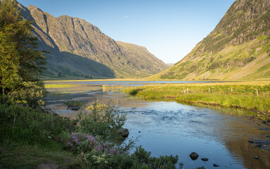 Scenic view of Loch Achtriochtan and river Coe in Glen Coe, Scottish Highlands, UK. Tranquil scene, beautiful and wild nature at sunset in summer