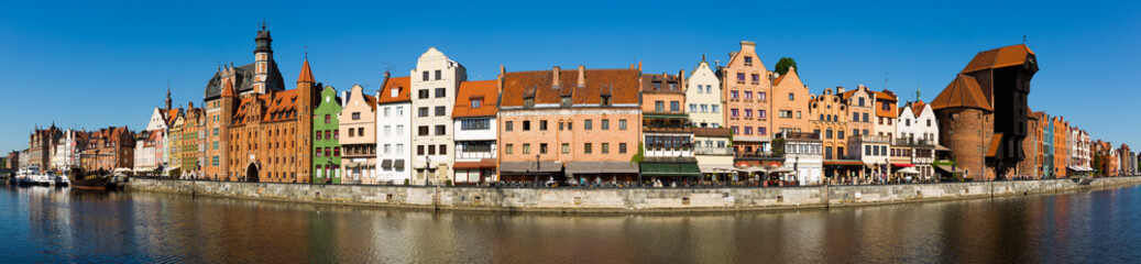 Naklejka na ściany i meble Image of embankment in historical part of Gdansk at sunny day, Poland