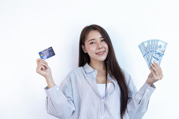 Young Asian woman holding a credit card and smiling happily.