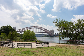 Fototapeta na wymiar Astoria Queens Riverfront Park along the East River in New York City during Summer with the Hell Gate Bridge