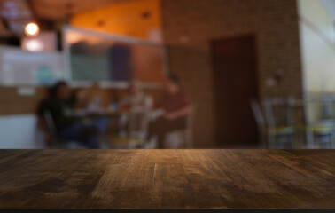 Empty dark wooden table in front of abstract blurred bokeh background of restaurant . can be used for display or montage your products.Mock up for space.