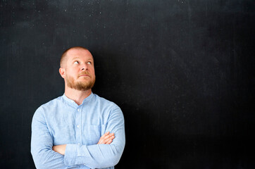 Businessman in front of the blank blackboard