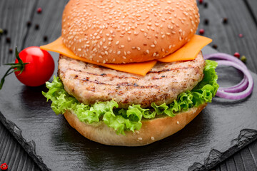 Chicken burger with tomatoes, lettuce and sauce