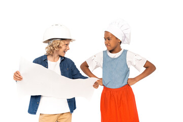 boy in costume of architect holding blueprint and looking at displeased african american kid standing with hands on hips isolated on white
