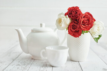Valentine day romantic breakfast with red roses and teapot. Happy Valentine's day greeting card. Mothers and women's day congratulations. Happy Birthday! Wedding invitation. Love concept.