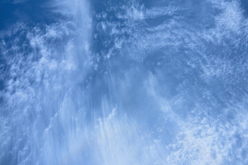 Dynamic of emotional cloudscape in blue sky background. Changes  atmosphere wave-like cloud in windy overcast summer day.