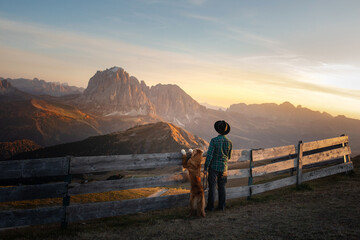 a man with a dog . travel with a pet. Dolomites Alps. hiking, relax.