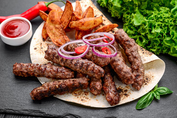 lula kebab with potatoes, vegetables and sauce