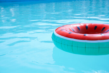 Inflatable ring in swimming pool on sunny day. Space for text