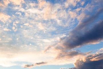 Naklejka na ściany i meble Bright cumulus clouds against the blue sky. Sunset sky Natural background.