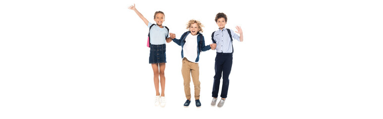 panoramic concept of curly schoolboys holding hands with schoolgirl and jumping isolated on white