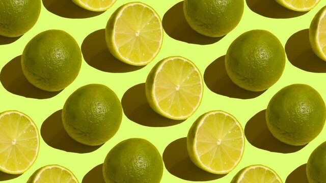 Stop Motion Cut and whole green limes alternating diagonally on a green background