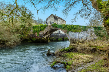 Fototapeta na wymiar A view of the nineteenth-century mill and bridge at Slebech, Wales