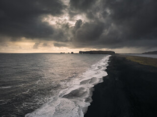 Aerial drone view of Reynisfjara Black Sand Beach nature landscape in South Iceland near Vik village at sunset