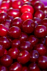 Background or texture of freshly picked red cherries. Various shades of red. Natural vitamins. Natural background.
