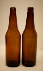 Two dark empty beer bottles.