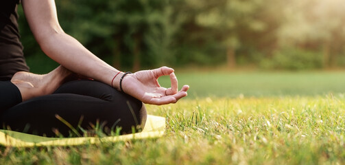 Close up of young woman practicing yoga in the back yard with copy space