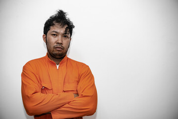 Prisoner in orange robe concept,Portrait of asian handsome man in Prison uniforms,Bandit has a lot of muscle,