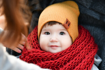 child in a red knitted scarf