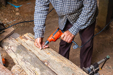 Carpenter is working to drill wood