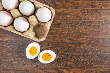 White duck eggs and salted egg food on a wooden table