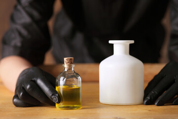 picture of female hands with oil bottle