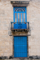 Fototapeta na wymiar Blue Door and window of a colonial house, Havana old City, Cuba, Unesco World Heritage Site.