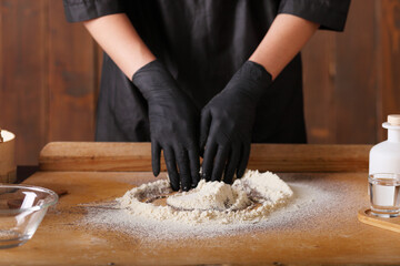 Close up of woman`s hands making a bread.