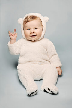 Ice Bear costumed Baby making the Devils Horn Sign
